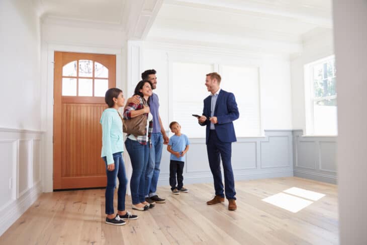 Family touring a home with a real estate agent.
